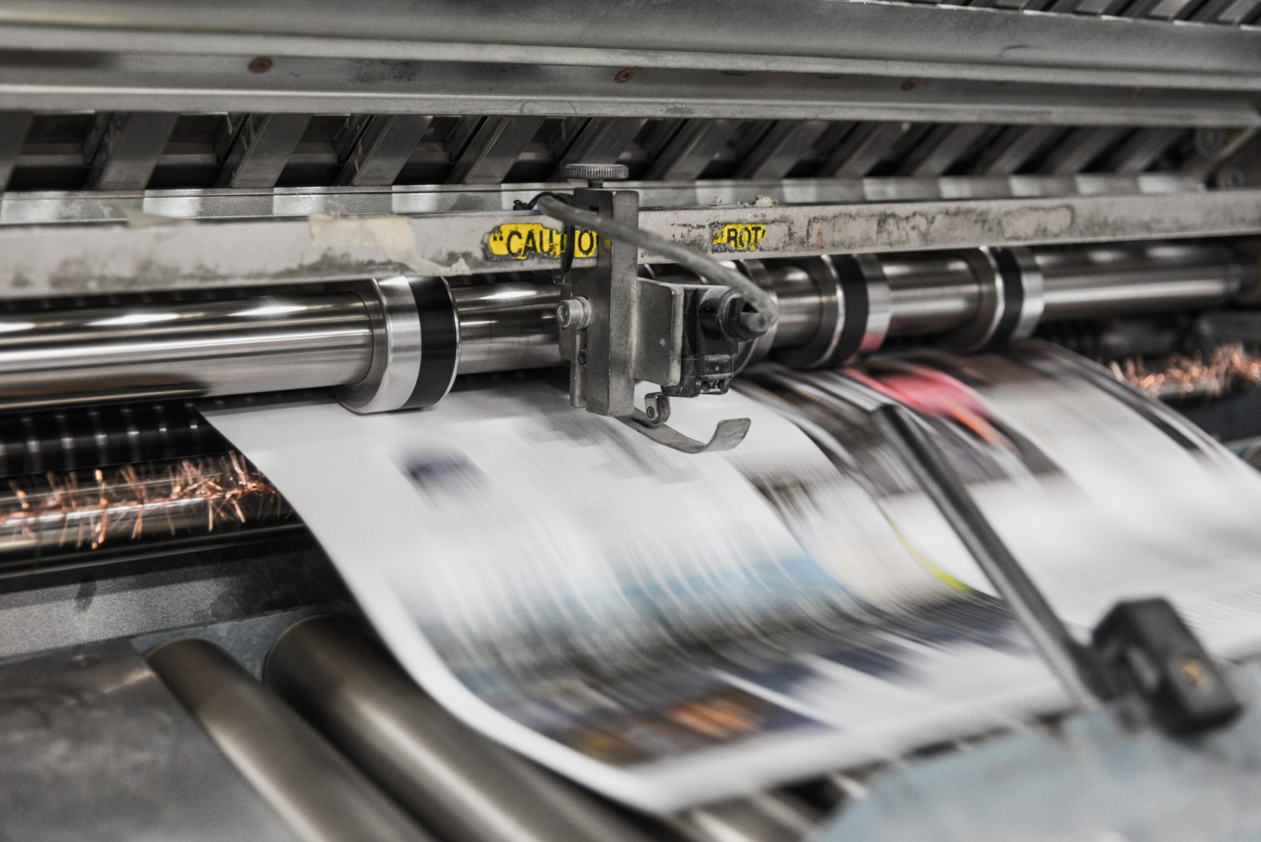 A modern newspaper press printing a newspaper
